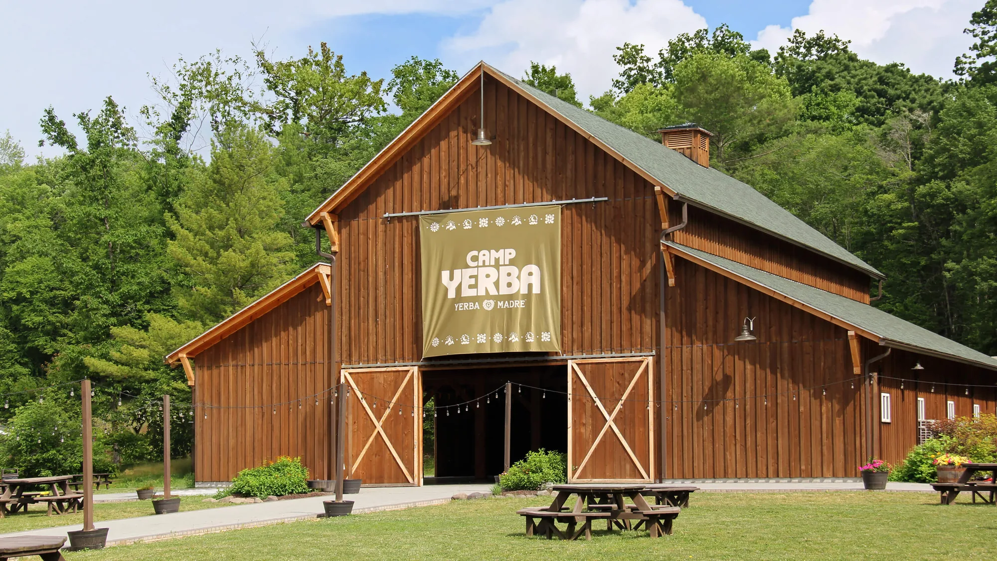 Wooden barn in the Poconos with the Camp Yerba banner over its doors