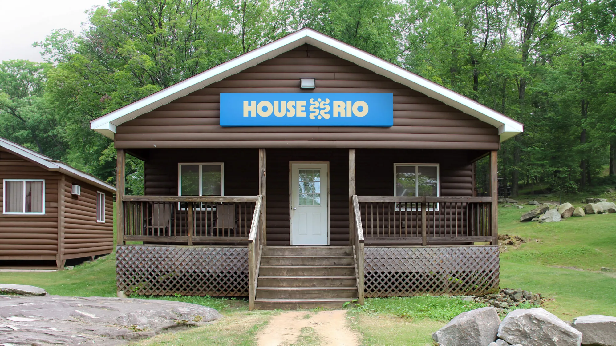 Cabin with the blue House Rio sign over the porch