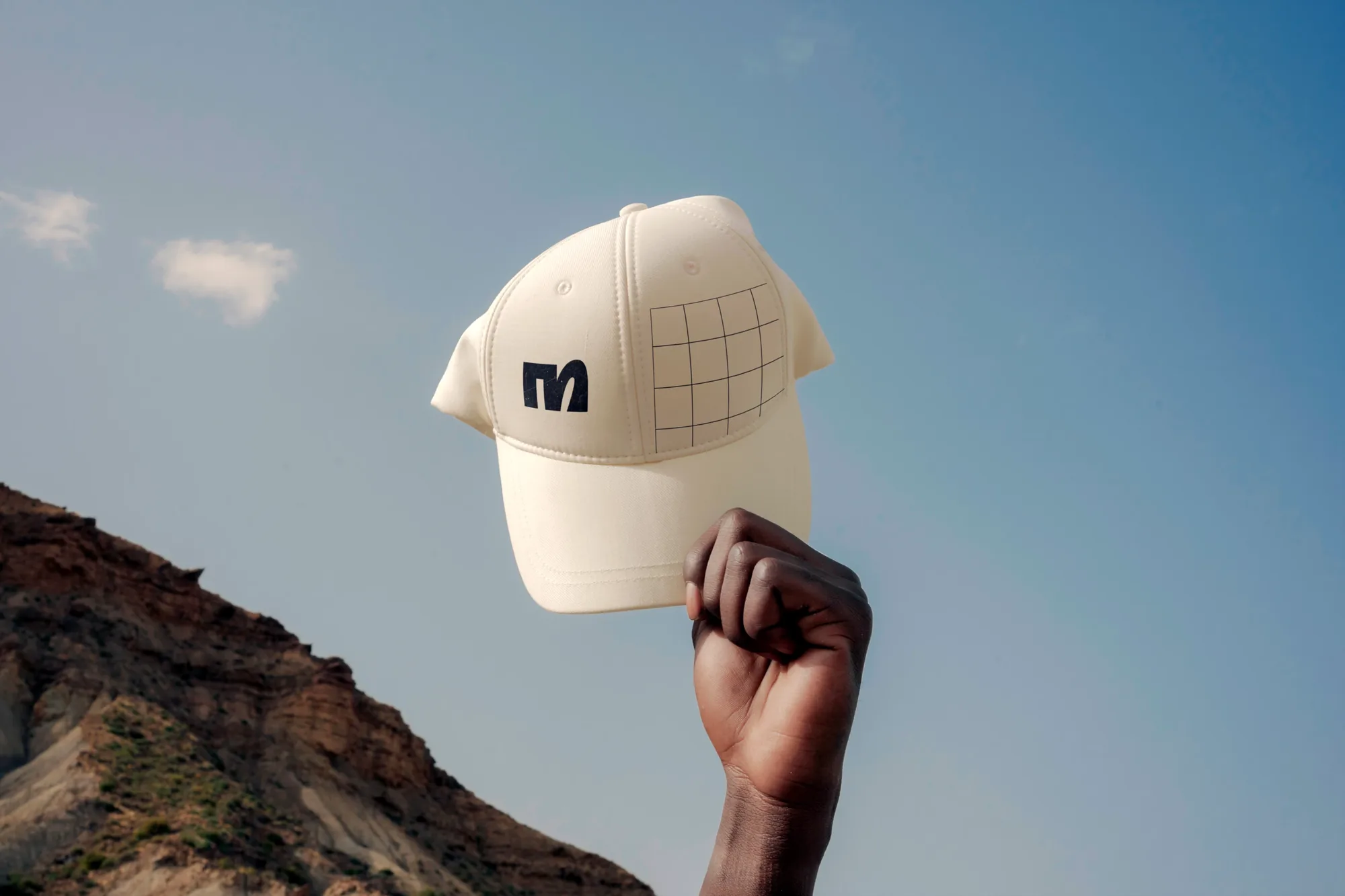 Cap with the M monogram against the sky