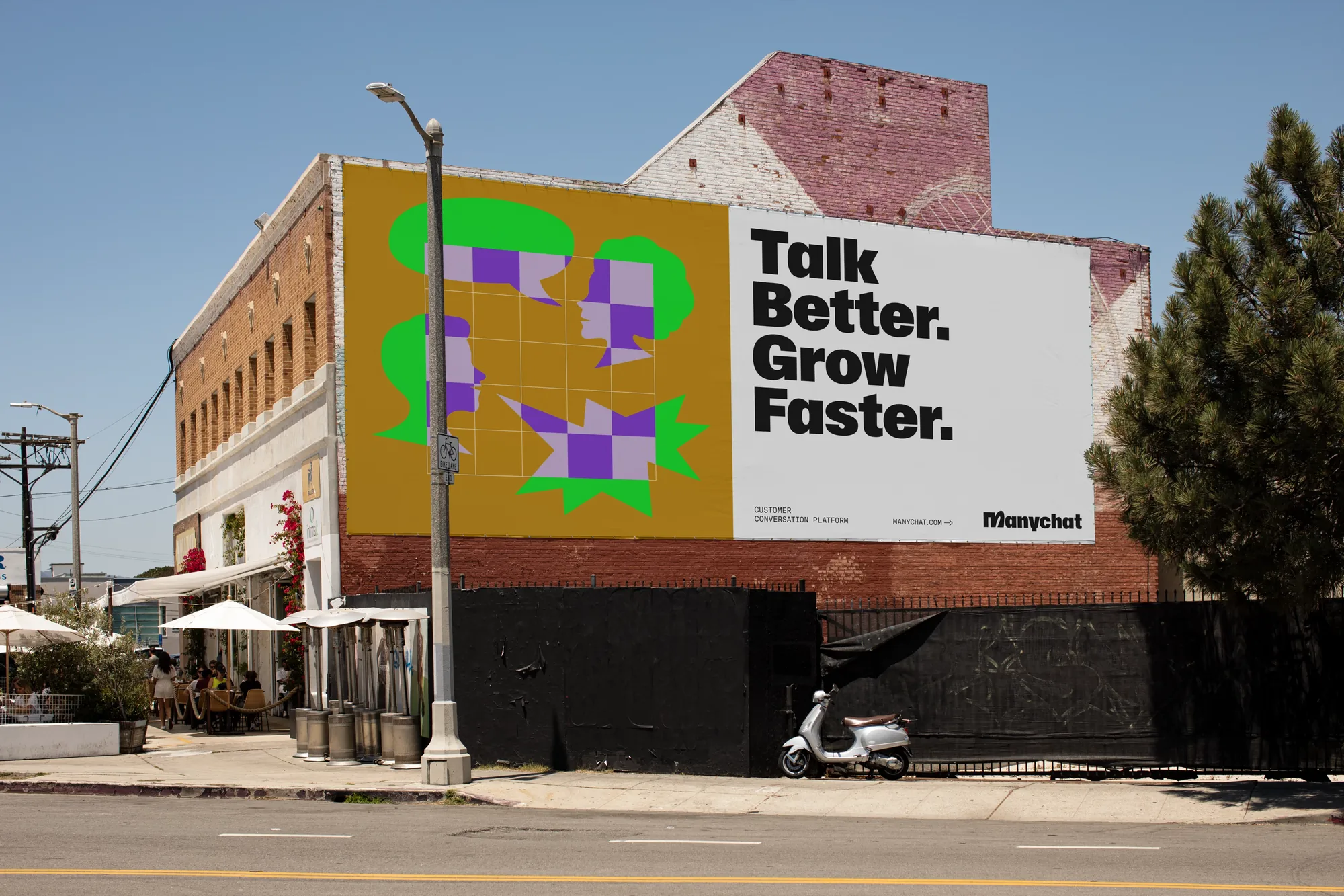 Billboard on a brick building: Talk Better. Grow Faster.