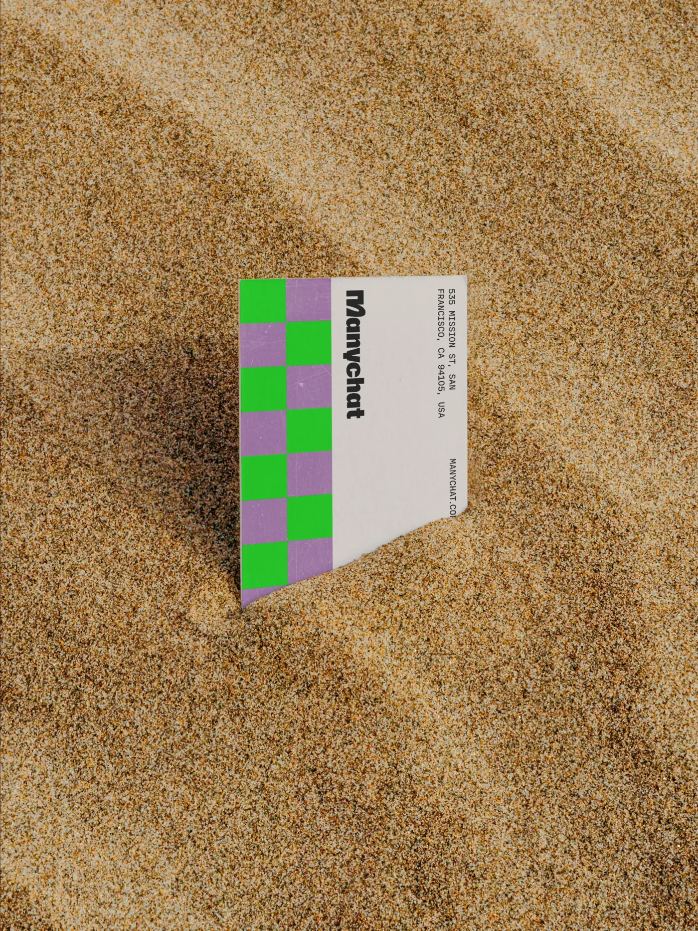 Manychat business card in the sand