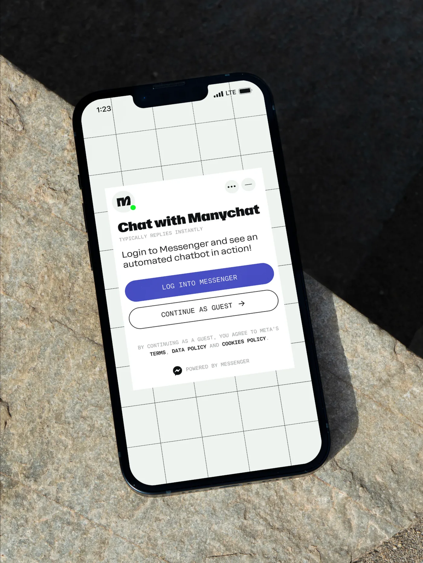 Manychat chat flow on a phone lying on rock