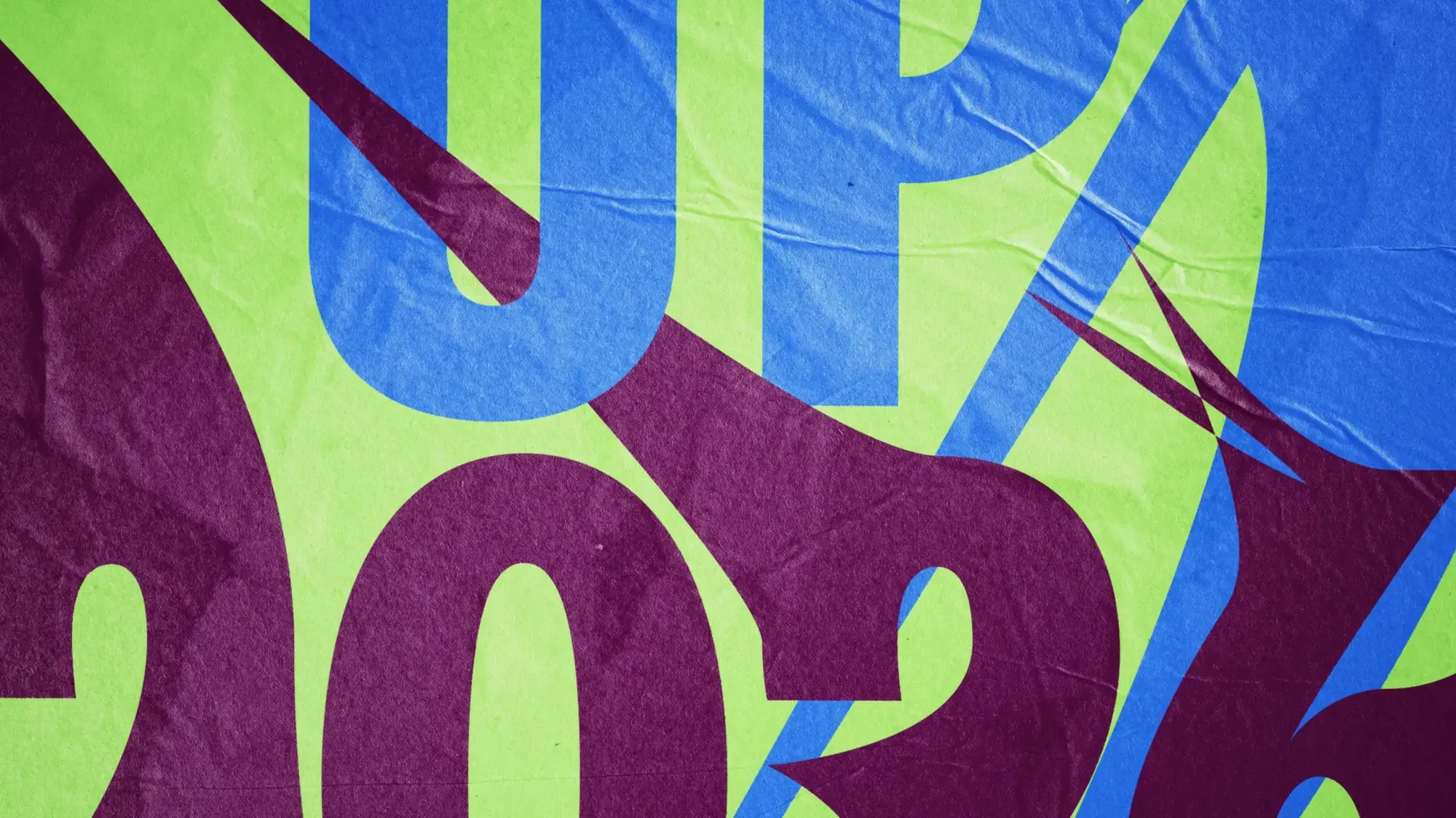 Close-up of the Warm Up 2026 poster on wrinkled paper