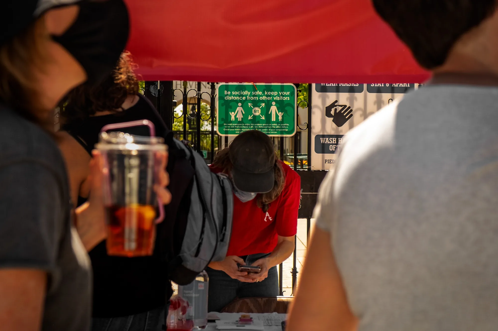Piedmont Art Walk information booth with a volunteer in the red event tee