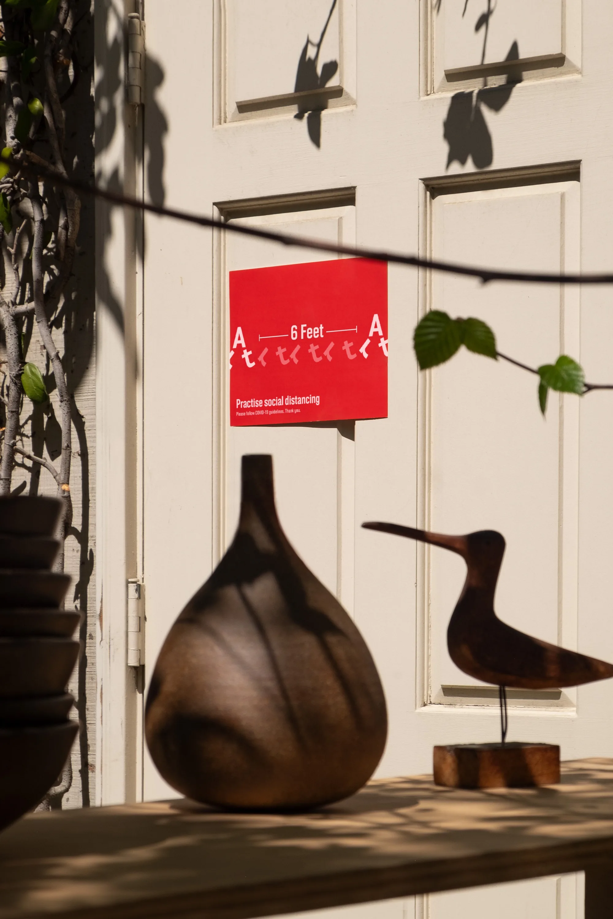 Six feet apart sign at an artist's front door