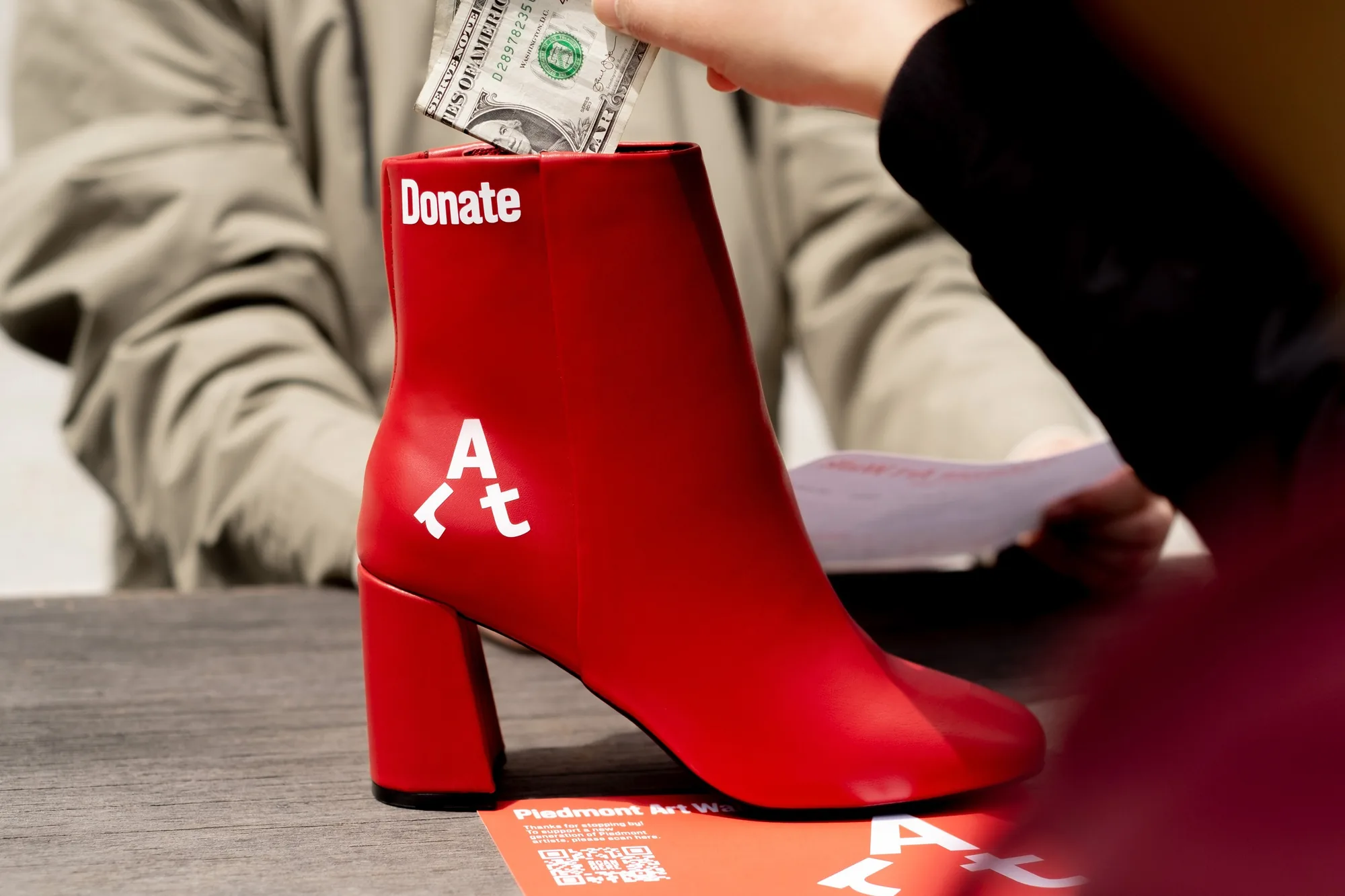 Red boot used as a donation box at the Piedmont Art Walk
