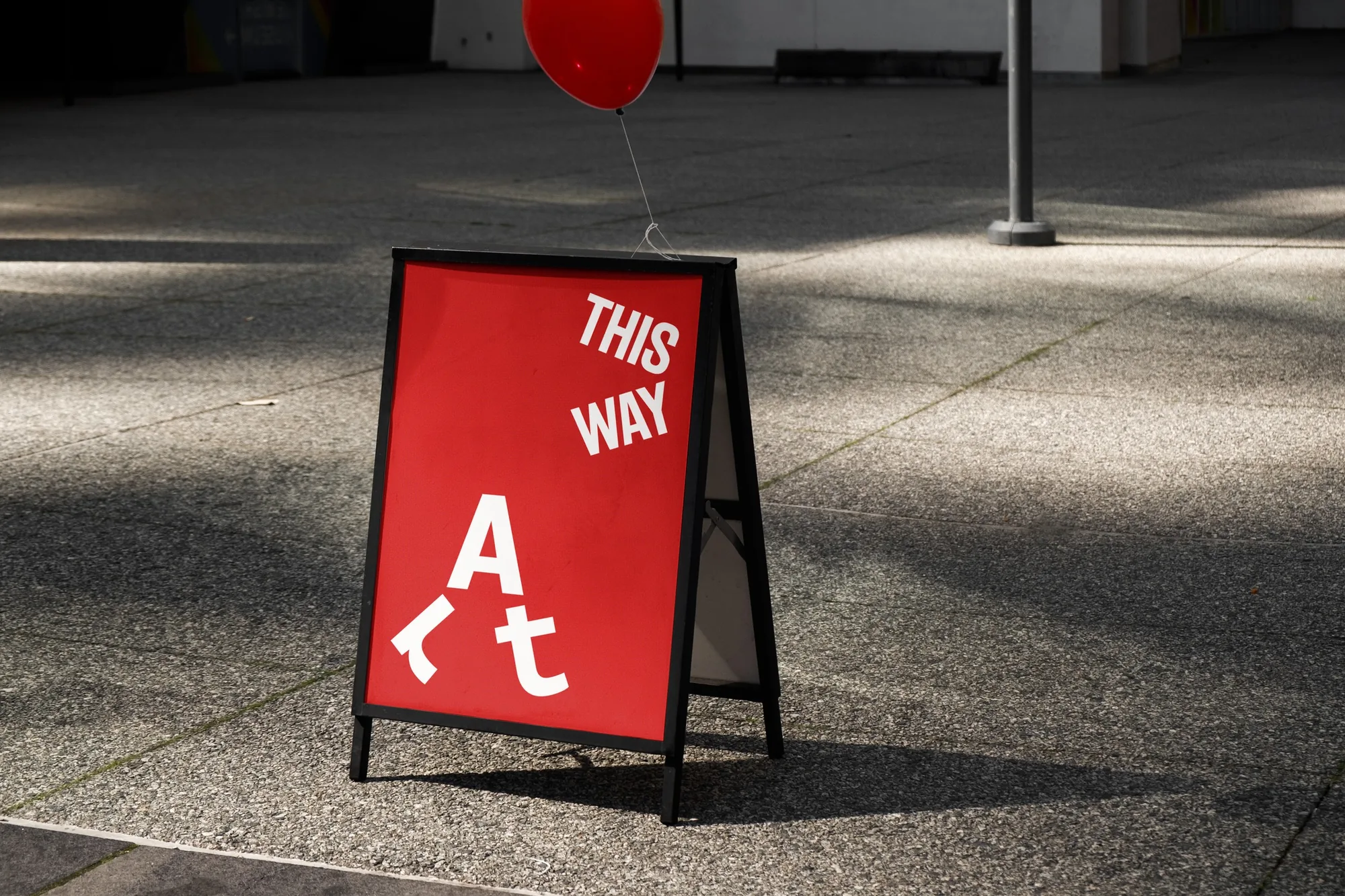 This way sandwich board with the walking Art symbol