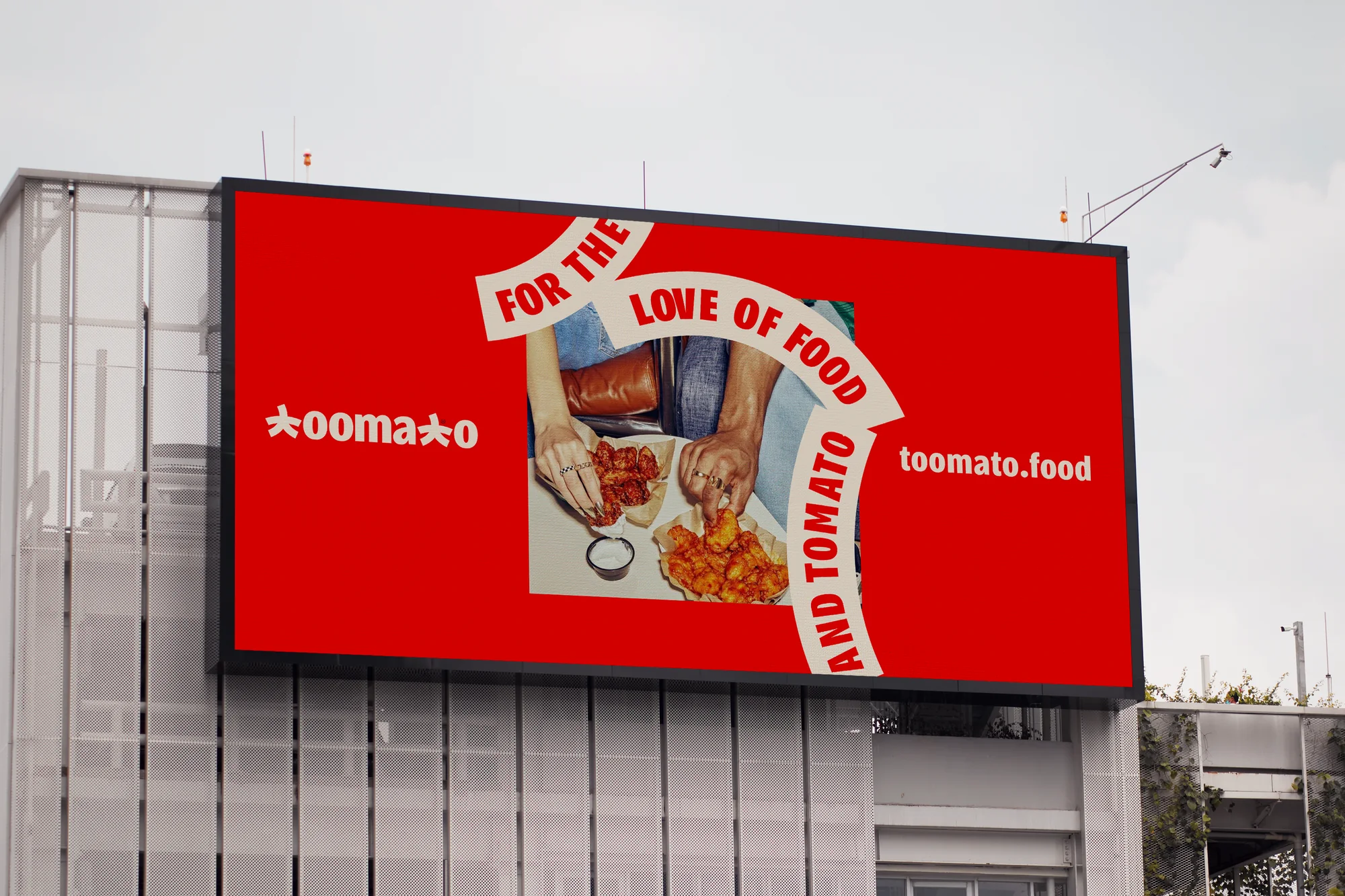 Toomato billboard on an office building with the ribbon wrapped around a food photo