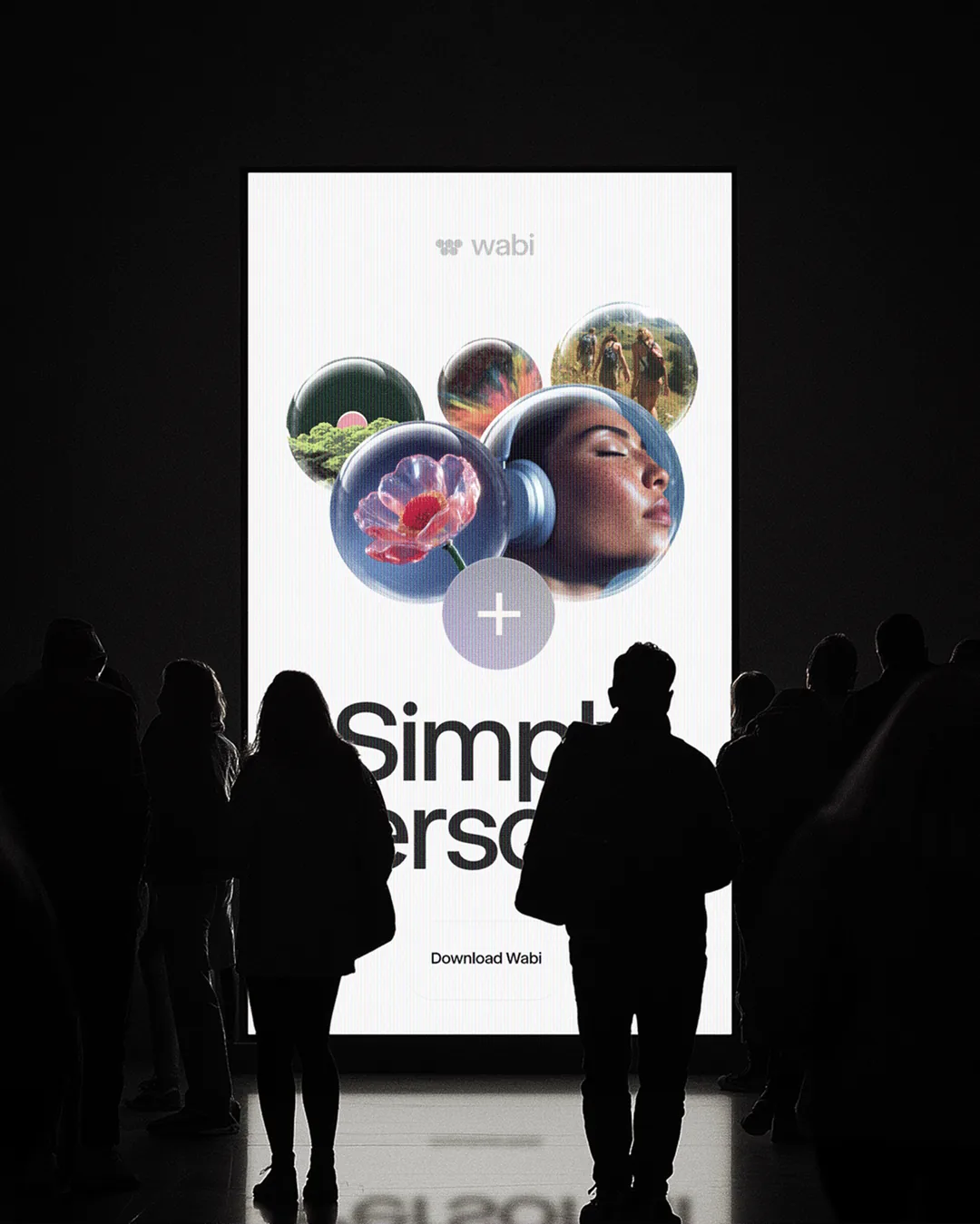 People in silhouette in front of a glowing Simply Personal screen