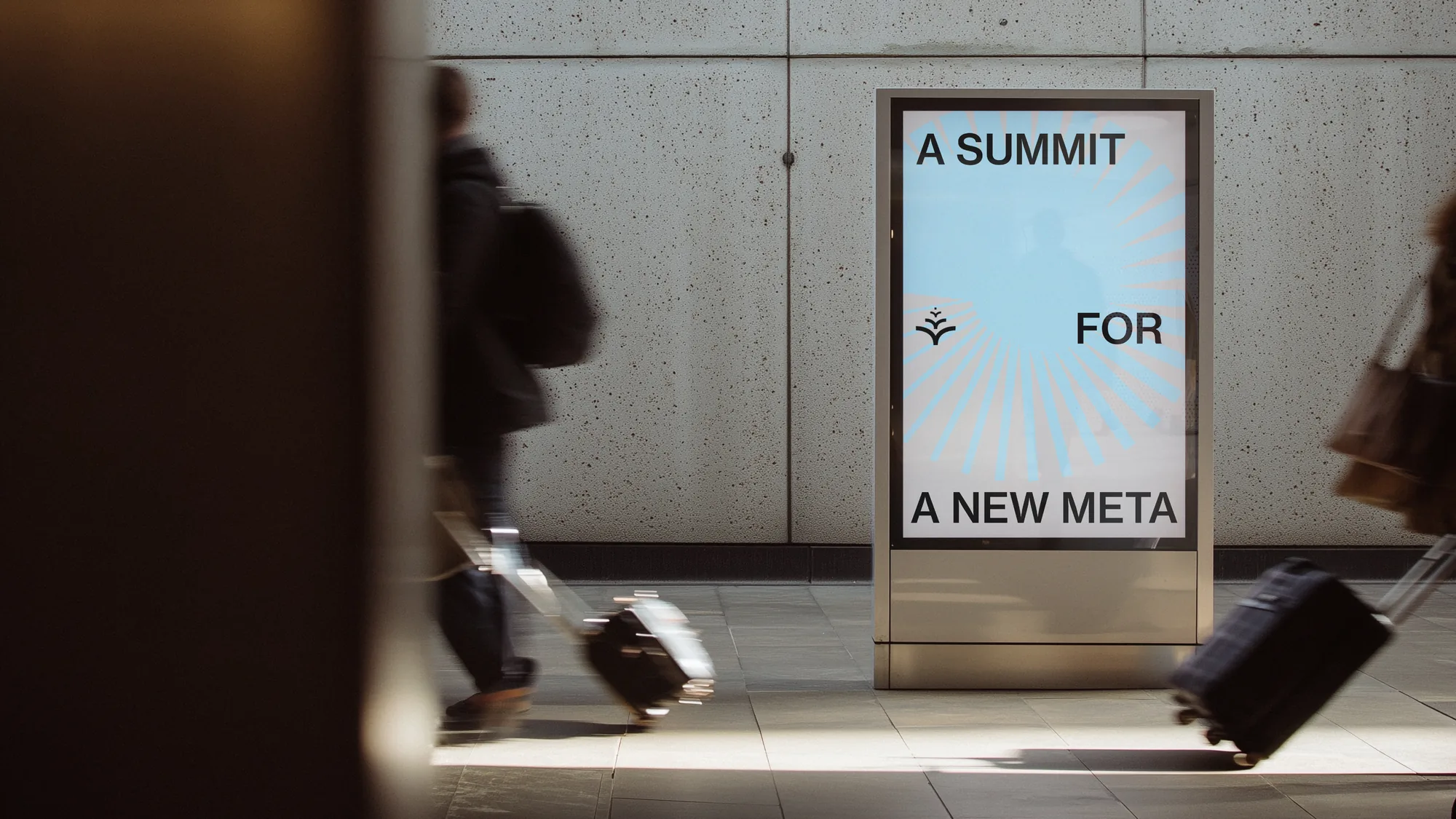 Yield digital poster in a station with a traveller rolling a suitcase past