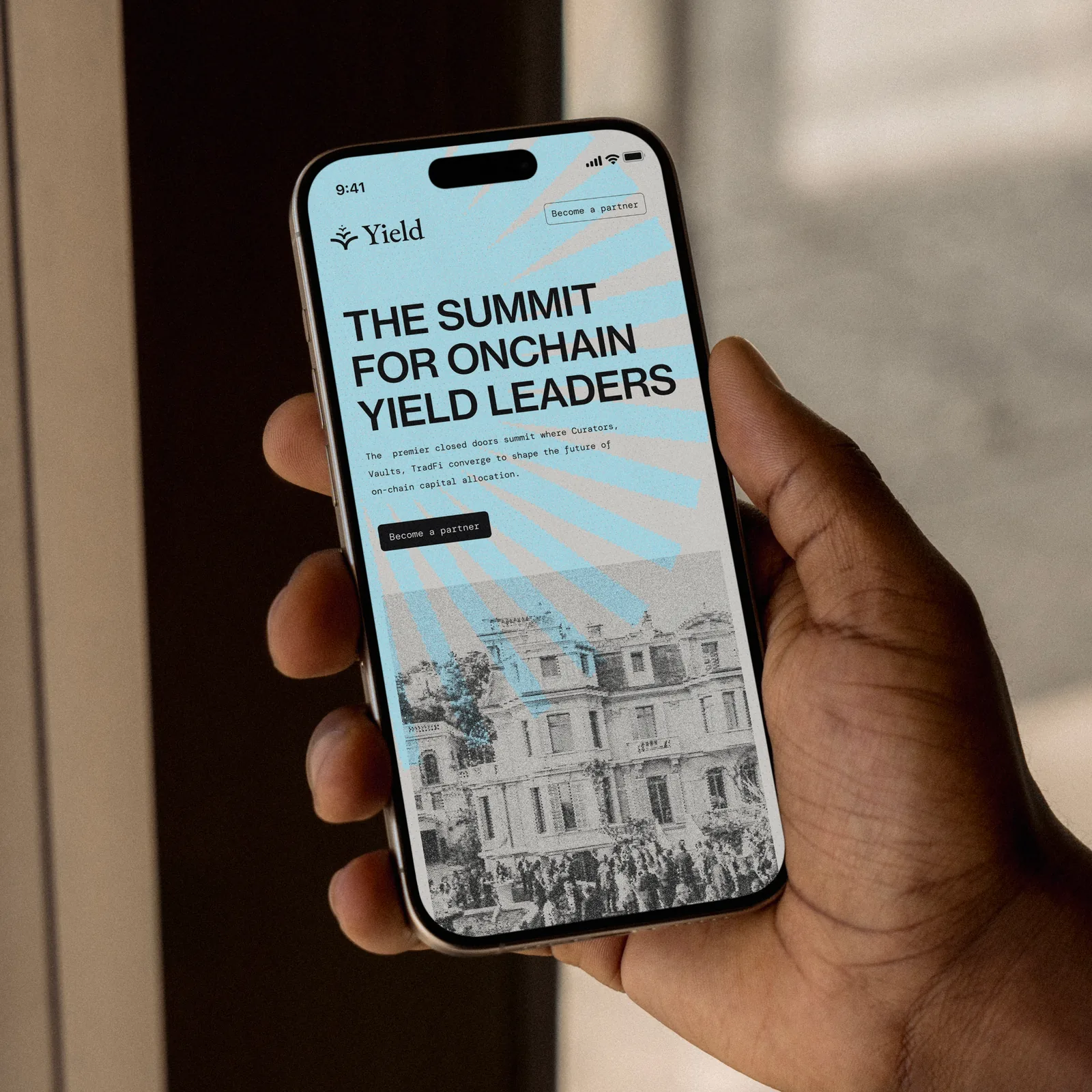 Hand holding a phone with the Yield website, The summit for onchain yield leaders